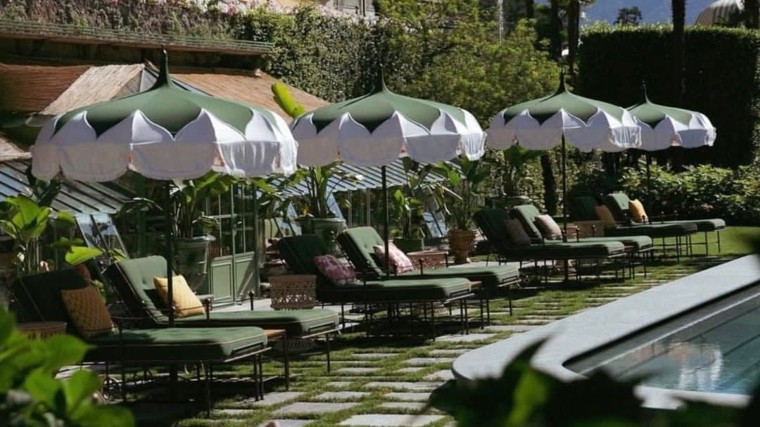Atlas interiors - 4 ways travel inspires us and how it translates into the home. Green & white umbrellas and green lounge chairspool side