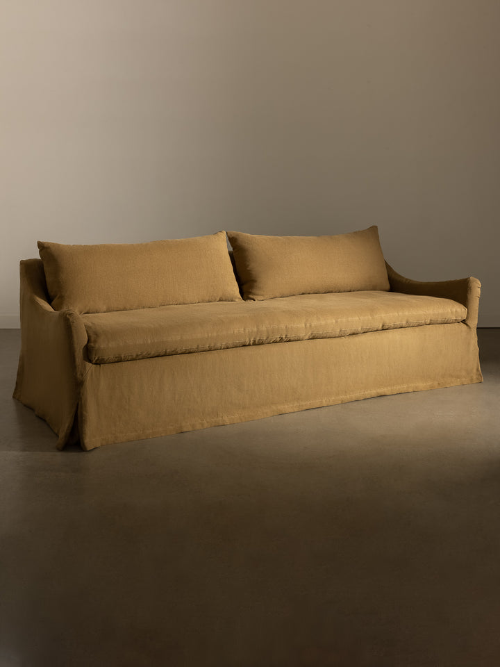 Rachel Donath Louis Caramel sofa against a plain wall