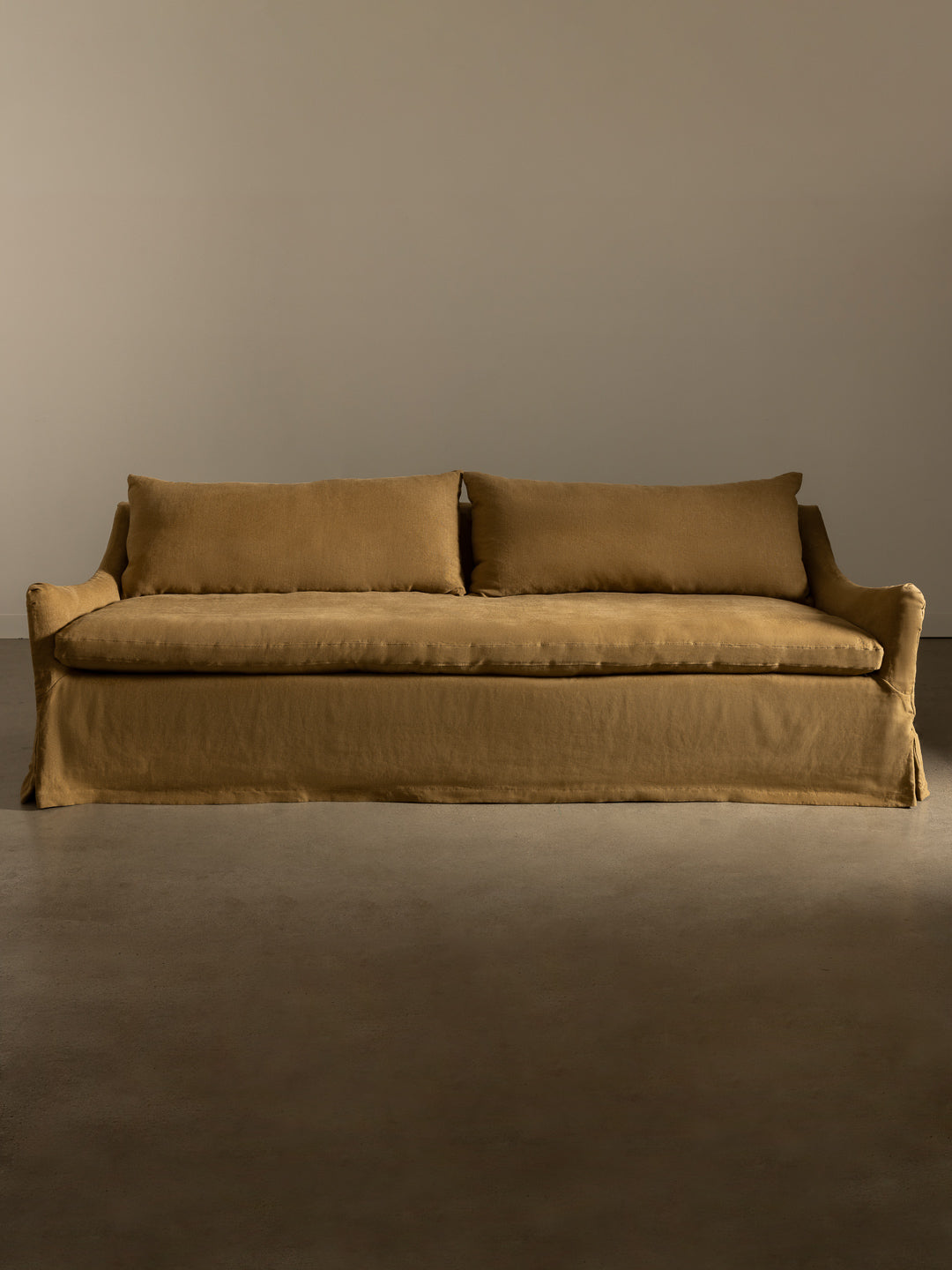 Rachel Donath Louis Caramel sofa against a plain wall