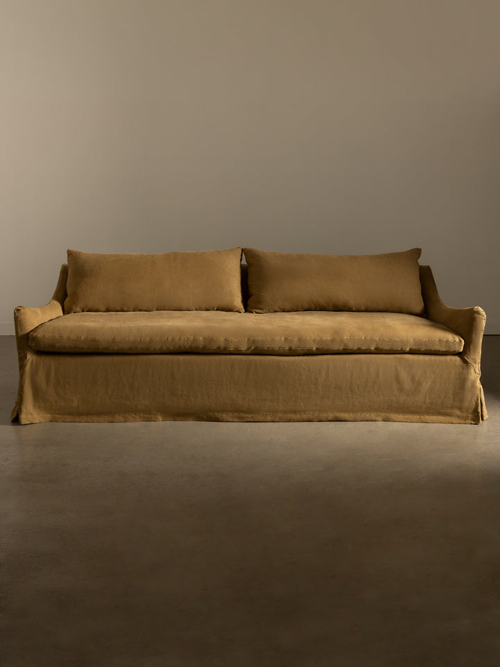 Rachel Donath Louis Caramel sofa against a plain wall