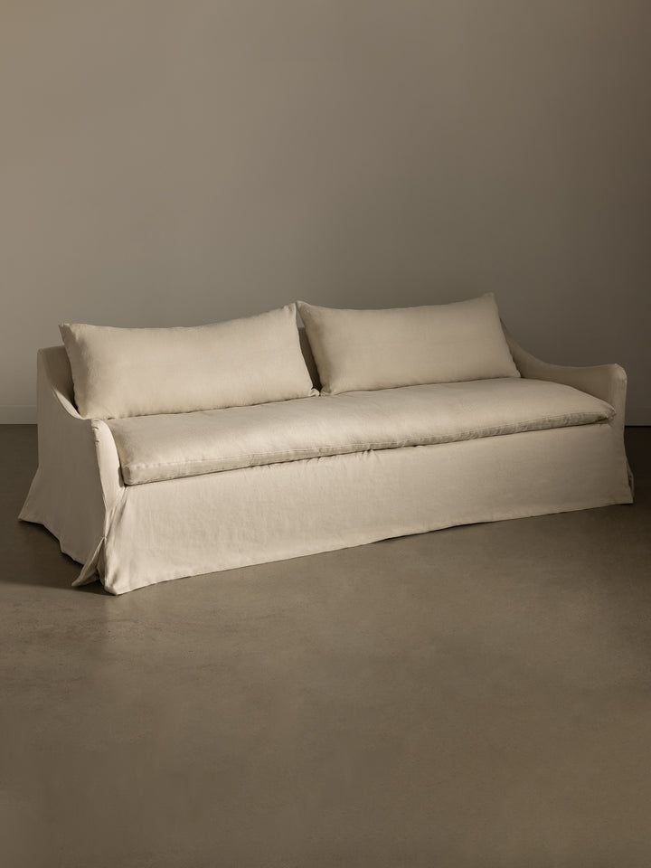 Rachel Donath Louis Creme Sofa against a plain wall.